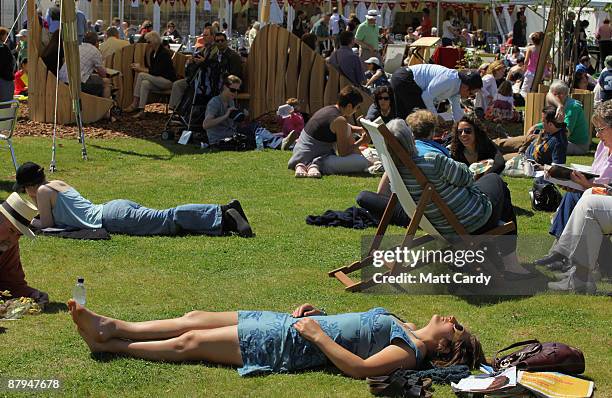 Festival-goers enjoy the fine weather during the fourth day of the Guardian Hay Festival 2009 on May 24, 2009 in Hay-on-Wye, Wales. Sky Arts once...