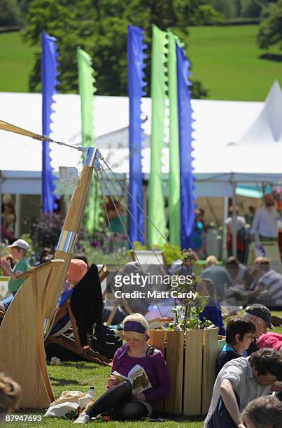 Festival-goers enjoy the fine weather during the fourth day of the Guardian Hay Festival 2009 on May 24, 2009 in Hay-on-Wye, Wales. Sky Arts once...