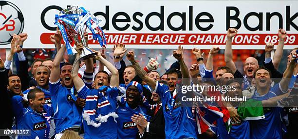 Rangers players celebrate winning the Scottish Premier League trophy after the Scottish Premier League match between Dundee United and Rangers at...