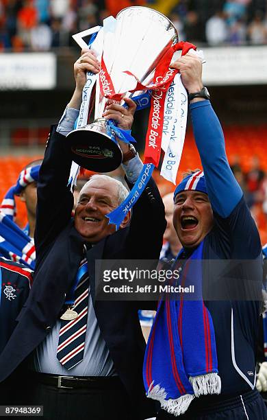 Walter Smith and Ally McCoist of Rangers celebrate winning the Scottish Premier League trophy after the Scottish Premier League match between Dundee...
