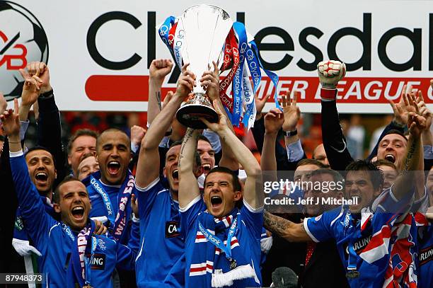 Rangers players celebrate winning the Scottish Premier League trophy after the Scottish Premier League match between Dundee United and Rangers at...