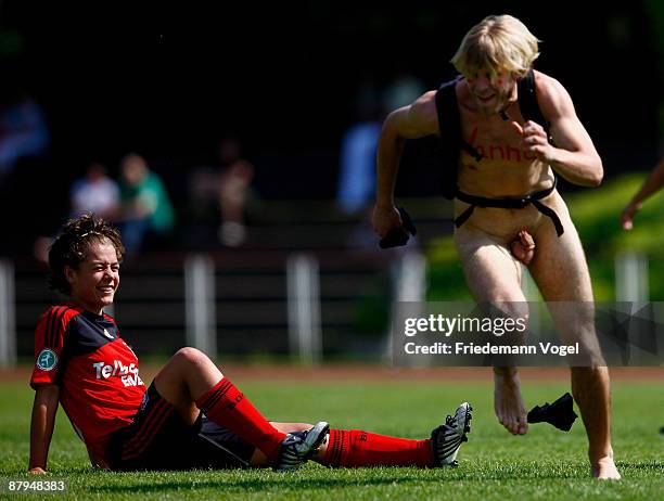 Streaker runs to Vanessa Wurth of Leverkusen during the Women's 2. Bundesliga match between Bayer 04 Leverkusen and 1. FC Saarbruecken at the...