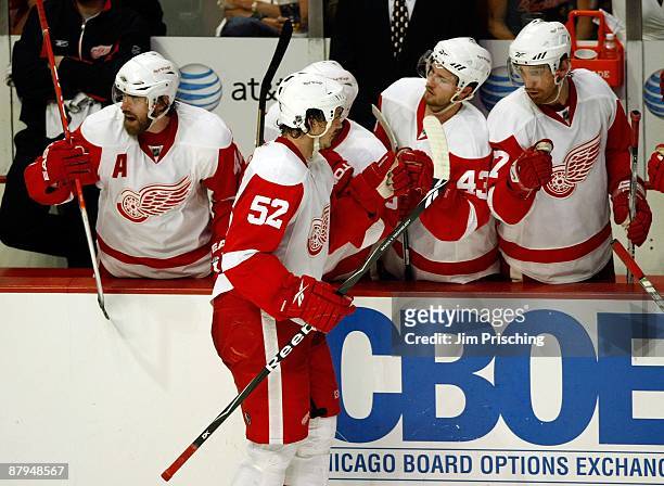 Jonathan Ericsson of the Detroit Red Wings celebrates with his teammates after he scored a goal in the second period against the Chicago Blackhawks...