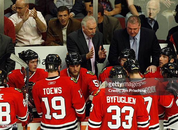 Head coach Joel Quenneville of the Chicago Blackhawks talks with his players during a timeout against the Detroit Red Wings during Game Three of the...
