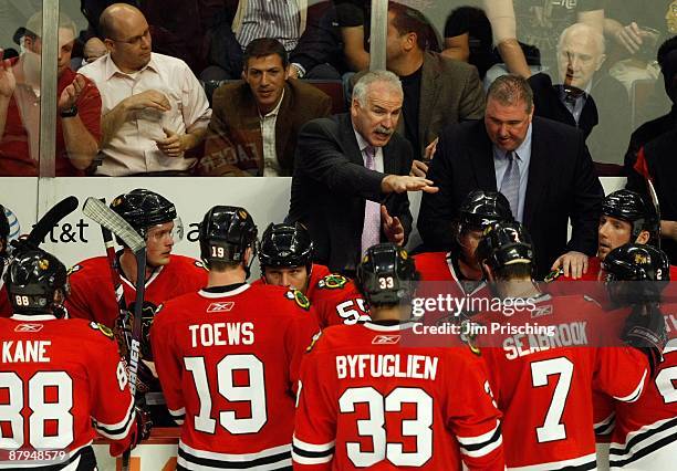 Head coach Joel Quenneville of the Chicago Blackhawks talks with his players during a timeout against the Detroit Red Wings during Game Three of the...