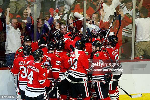 The Chicago Blackhawks celebrate with their fans after their 4-3 win in overtime against the Detroit Red Wings during Game Three of the Western...