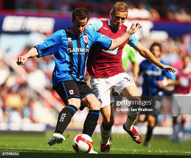 Matthew Bates of Middlesbrough holds off Jack Collison of West Ham United during the Barclays Premier League match between West Ham United and...