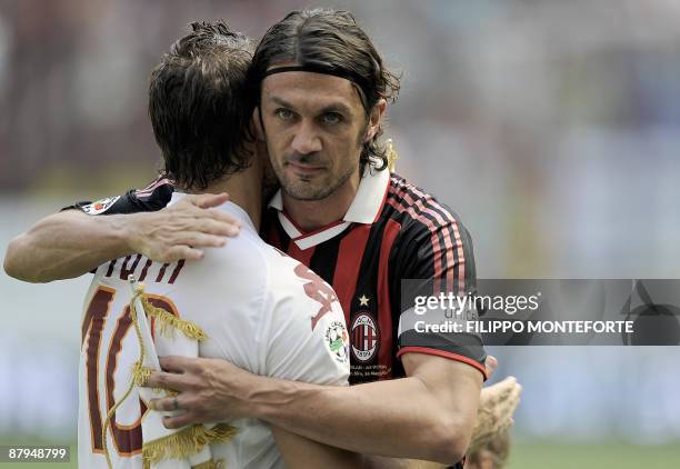 Roma's forward and captain Francesco Totti hugs AC Milan's defender and captain Paolo Maldini before their Serie A football match in Milan San Siro...