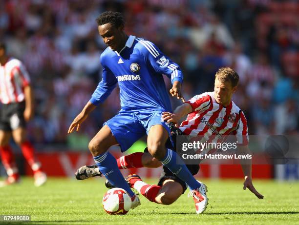 Teemu Tainio of Sunderland tackles John Mikel Obi of Chelsea during the Barclays Premier League match between Sunderland and Chelsea at The Stadium...