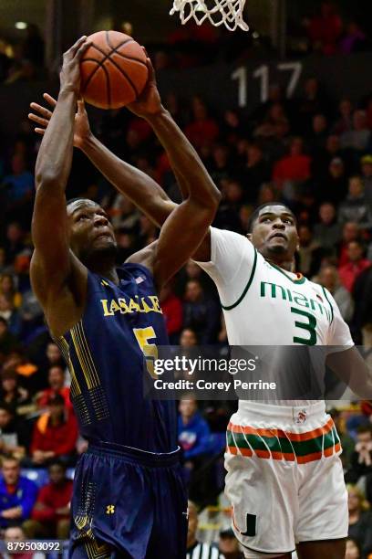 Tony Washington of the La Salle Explorers goes up for a dunk against Anthony Lawrence II of the Miami Hurricanes during the first half at Santander...