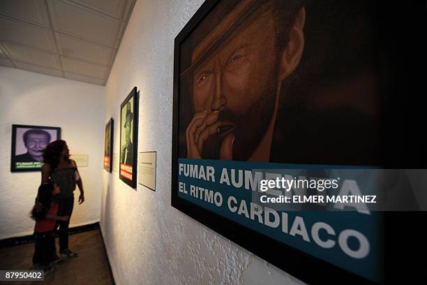 By Juan Jose Rodriguez A woman visits the exhibition ''Fumar es nocivo'' by Panamanian artist Felipe Diaz in Panama City, on May 23 2009. Diaz's work...