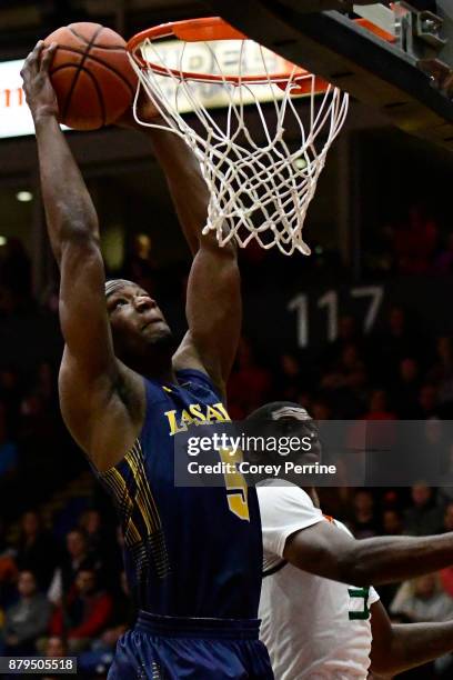 Tony Washington of the La Salle Explorers goes up for a dunk against Anthony Lawrence II of the Miami Hurricanes during the first half at Santander...