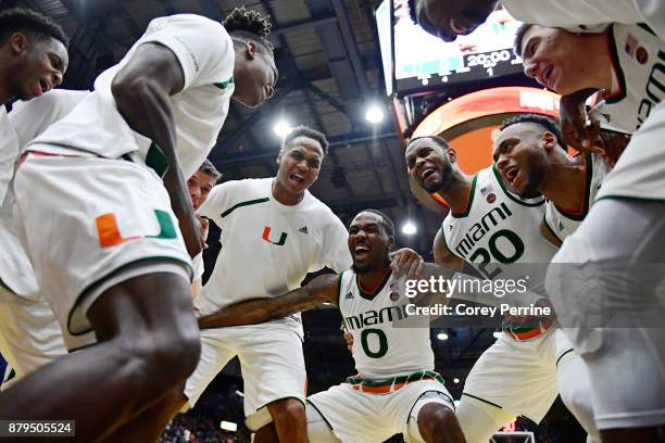 Ja'Quan Newton of the Miami Hurricanes gets fired up with his teammates Rodney Miller , Dewan Huell and others before the game against the La Salle...