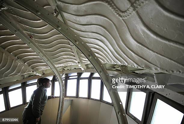 United States Park Ranger Kenya Finley looks out the window of the crown of the Statue of Liberty during a media tour May 20, 2009. On July 4 the...