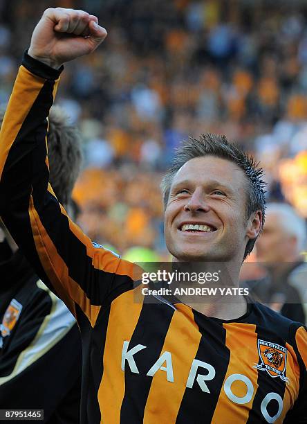 Hull City's English midfielder Nick Barmby celebrates on the pich after they avoid relegation after the English Premier League football match between...