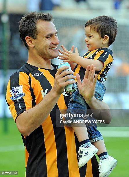 Hull City's Australian midfielder Richard Garcia celebrates on the picht after they avoid relegation after the English Premier League football match...