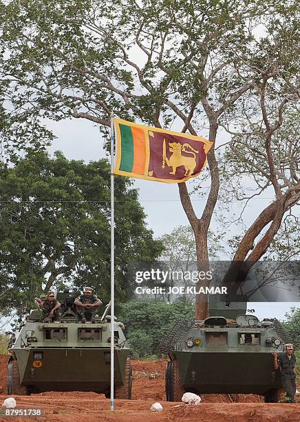Sri Lankan soldiers stand guard on armoured personnel carriers during United Nations Secretary-General Ban Ki-moon's visit to Menik Farm refugee camp...