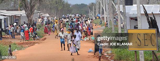 Internally displaced Sri Lankan people walk in a lane between tents during a visit by United Nations Secretary-General Ban Ki-moon at Menik Farm...