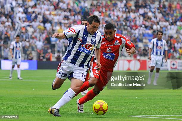 Christian Gimenez of Pachuca vies for the ball with Tomas Campos of Indios during their semifinal match valid for the 2009 Clausura tournament, the...