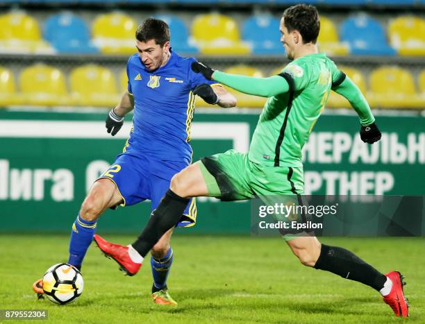 Aleksei Ionov of FC Rostov Rostov-on-Don vies for the ball with Vladimir Poluyakhtov of FC Anzhi Makhachkala during the Russian Premier League match...