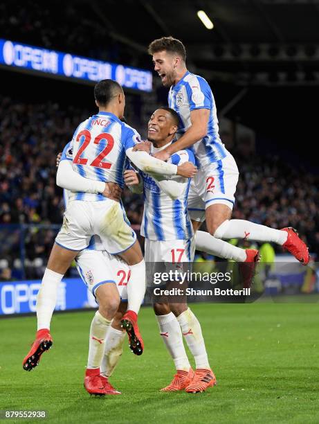 Tom Ince, Christopher Schindler, Rajiv van La Parra and Tommy Smith of Huddersfield Town celebrate after Nicolas Otamendi of Manchester City scored...