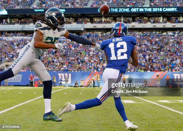 Richard Sherman of the Seattle Seahawks breaks up a pass intended for Tavarres King of the New York Giants on October 22, 2017 at MetLife Stadium in...
