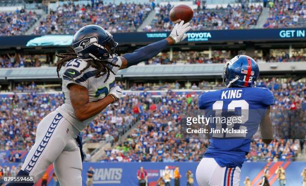 Richard Sherman of the Seattle Seahawks breaks up a pass intended for Tavarres King of the New York Giants on October 22, 2017 at MetLife Stadium in...