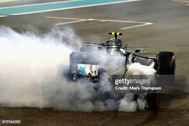 Race winner Valtteri Bottas driving the Mercedes AMG Petronas F1 Team Mercedes F1 WO8 celebrates with donuts on track during the Abu Dhabi Formula...