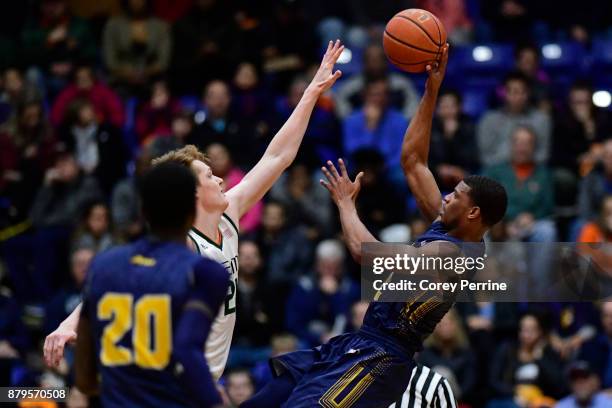 Amar Stukes of the La Salle Explorers hits a fade away jumper against Sam Waardenburg of the Miami Hurricanes during the second half at Santander...