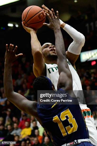 Bruce Brown Jr. #11 of the Miami Hurricanes shoots over Saul Phiri of the La Salle Explorers during the second half at Santander Arena on November...