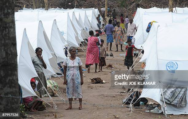 Internally displaced Sri Lankan people walk in the space between tents during a visit by United Nations Secretary-General Ban Ki-moon at Menik Farm...