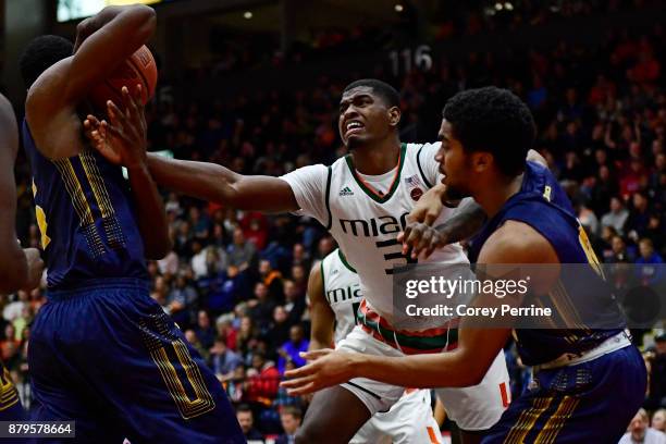 Anthony Lawrence II of the Miami Hurricanes fights for the ball from Tony Washington and Pookie Powell of the La Salle Explorers during the second...