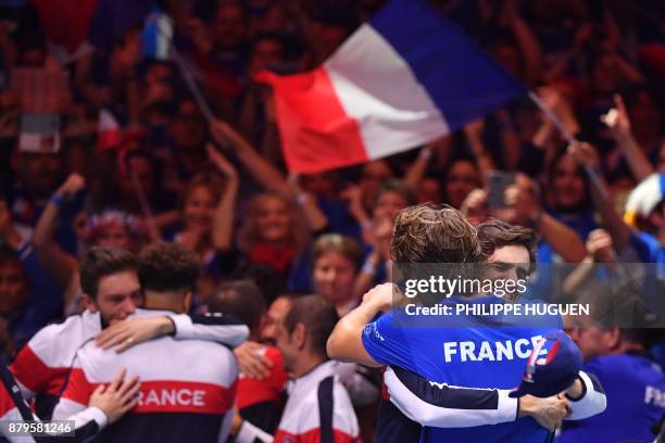 France's Pierre-Hugues Herbert celebrates Lucas Pouille after he won his singles rubber 5 match against Belgium's Steve Darcis at the Davis Cup World...