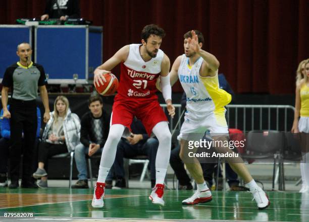 Sertac Sanli of Turkey in action against Vyacheslav Kravtsov of Ukraine during the FIBA Basketball World Cup 2019 group B qualifying match between...