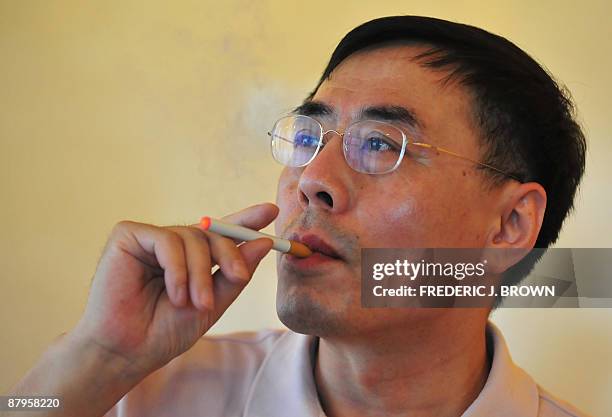 The inventor of the electronic cigarette, Hon Lik smokes his invention in Beiijng on May 25, 2009. Also known as an 'e-cigarette', the...