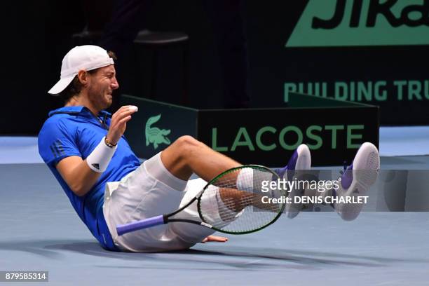 France's Lucas Pouille celebrates after winning his singles rubber 5 match against Belgium's Steve Darcis at the Davis Cup World Group final tennis...
