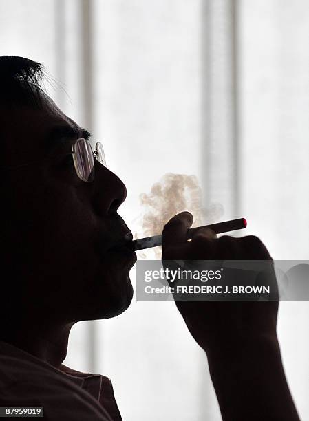 The inventor of the electronic cigarette, Hon Lik smokes his invention in Beiijng on May 25, 2009. Also known as an 'e-cigarette', the...