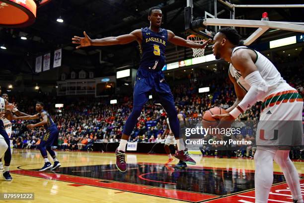 Tony Washington of the La Salle Explorers looks to block an inbound pass from Bruce Brown Jr. #11 of the Miami Hurricanes during the second half at...