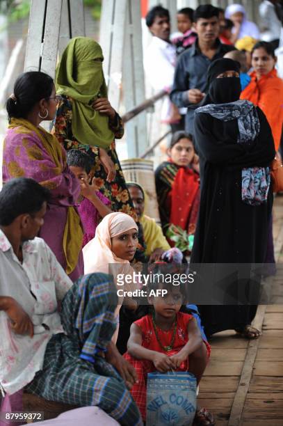 Bangladeshi passengers wait at the ferry terminal as river traffic is halted due to impending cyclone 'Aila' approaching Dhaka on May 25, 2009....