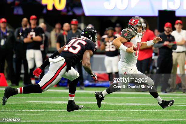 Ryan Fitzpatrick of the Tampa Bay Buccaneers runs the ball during the first half against the Atlanta Falcons at Mercedes-Benz Stadium on November 26,...