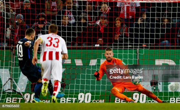 Vedad Ibisevic of Berlin scores his teams second goal against Timo Horn of Koeln during the Bundesliga match between 1. FC Koeln and Hertha BSC at...