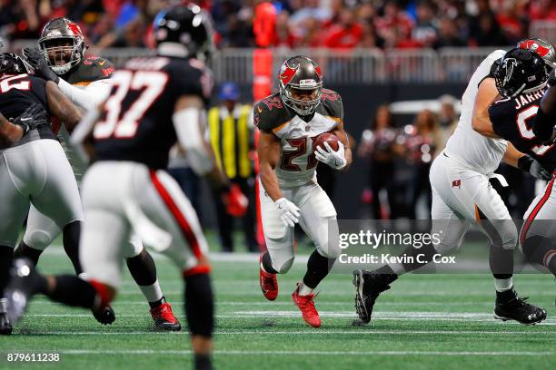 Doug Martin of the Tampa Bay Buccaneers runs the ball during the first half against the Atlanta Falcons at Mercedes-Benz Stadium on November 26, 2017...