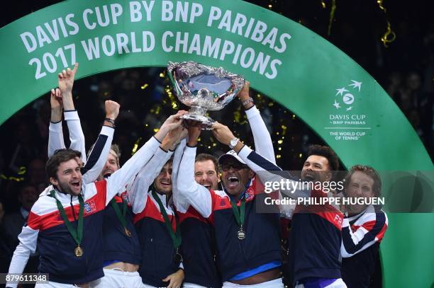 France's team pose with the trophy after winning the Davis Cup World Group final tennis match between France and Belgium at The Pierre Mauroy Stadium...