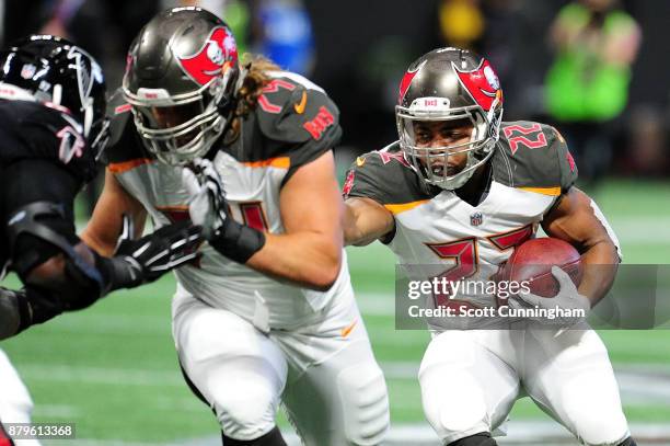 Doug Martin of the Tampa Bay Buccaneers runs behind a blocker during the first half against the TAtlanta Falcons at Mercedes-Benz Stadium on November...