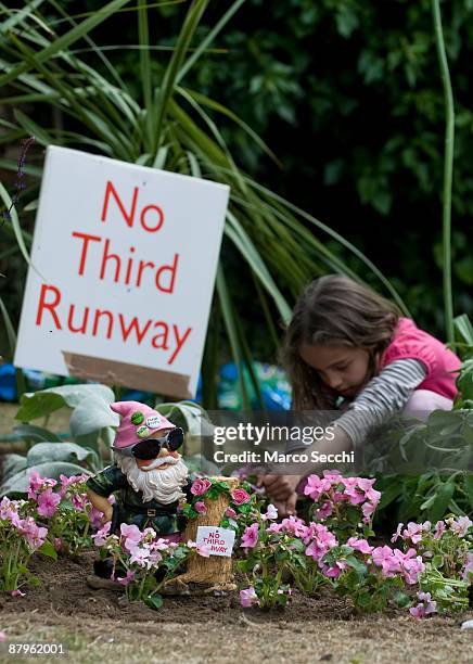 Guerrilla gardeners plant leftover plants from the Chelsea Flower Show at the site earmarked for Heathrow Airport's third runway in the village of...