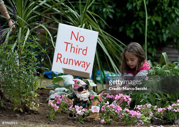 Guerrilla gardeners plant leftover plants from the Chelsea Flower Show at the site earmarked for Heathrow Airport's third runway in the village of...