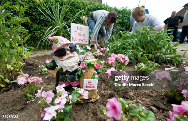 Guerrilla gardeners plant leftover plants from the Chelsea Flower Show at the site earmarked for Heathrow Airport's third runway in the village of...