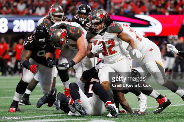 Jacquizz Rodgers of the Tampa Bay Buccaneers runs the ball during the first half against the Atlanta Falcons at Mercedes-Benz Stadium on November 26,...