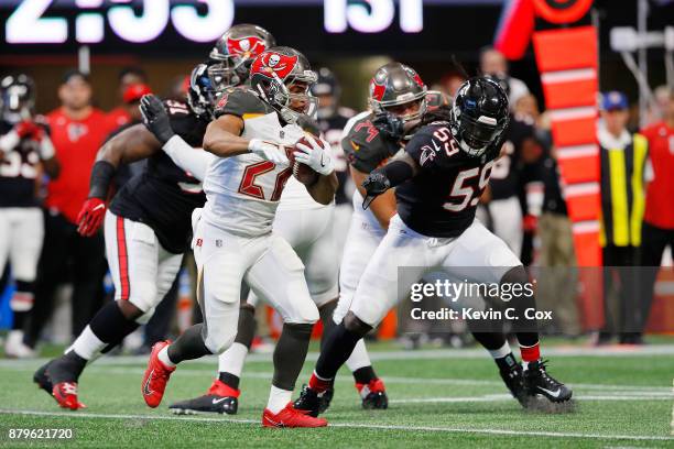 Doug Martin of the Tampa Bay Buccaneers runs the ball during the first half against the Atlanta Falcons at Mercedes-Benz Stadium on November 26, 2017...