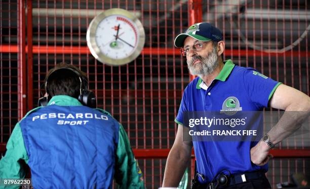 Head of the Pescarolo sport team and former Formula One driver Henri Pescarolo chats with staff members during the qualifying round of the 24 Heures...